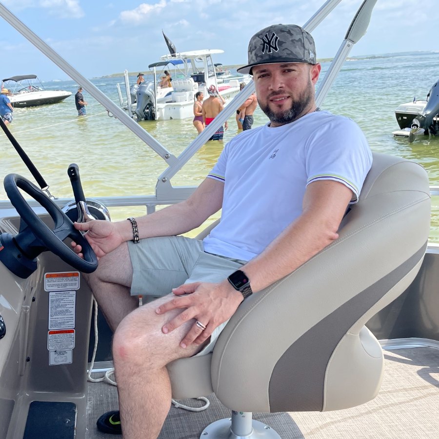 Eric Chez at the helm of his 20-foot pontoon anchored off Pine Key, also known as Beer Can Island, near Apollo Beach in upper Tampa Bay, May 2021.
